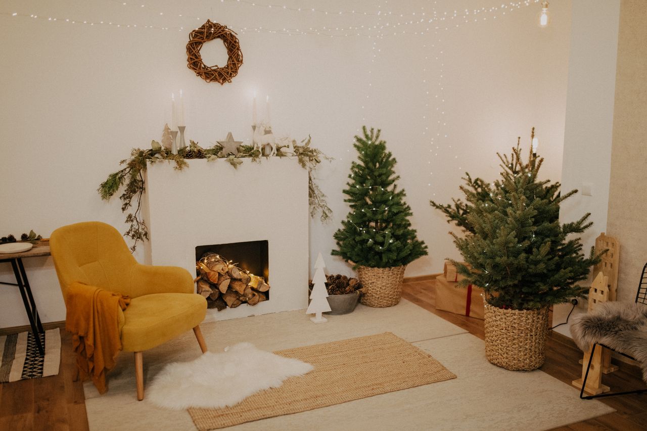 services-02 Warm and inviting living room with Christmas decorations, featuring a fireplace and festive decor.